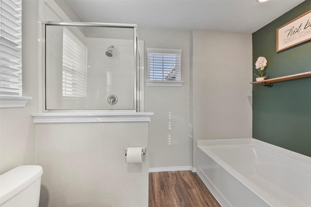 bathroom with toilet, hardwood / wood-style floors, and plus walk in shower