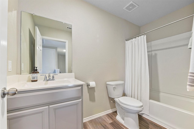 full bathroom with toilet, vanity, shower / bathtub combination with curtain, and hardwood / wood-style floors