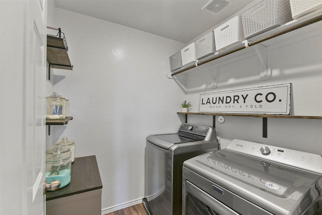 washroom featuring wood-type flooring and washer and dryer