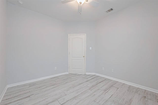 empty room with ceiling fan and light hardwood / wood-style floors