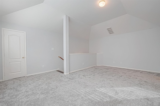 additional living space with vaulted ceiling and carpet floors