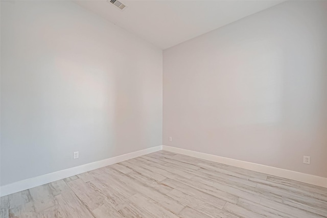 spare room featuring light hardwood / wood-style floors