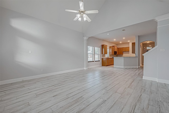 unfurnished living room featuring sink, light hardwood / wood-style flooring, high vaulted ceiling, and ceiling fan