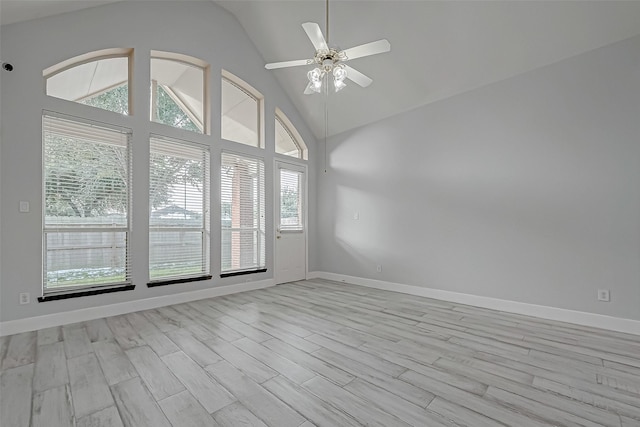 empty room featuring light hardwood / wood-style flooring, ceiling fan, and vaulted ceiling