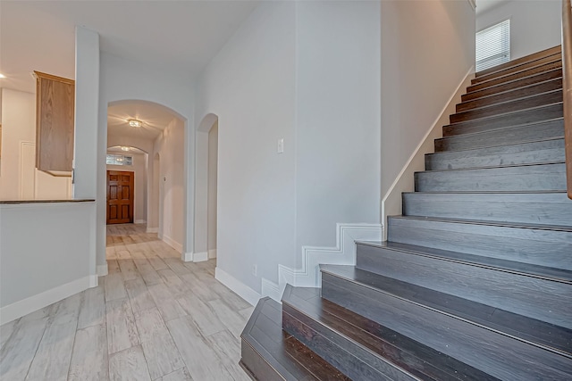 staircase with hardwood / wood-style floors