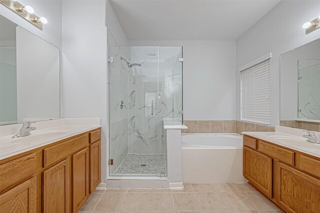 bathroom featuring vanity, plus walk in shower, and tile patterned flooring