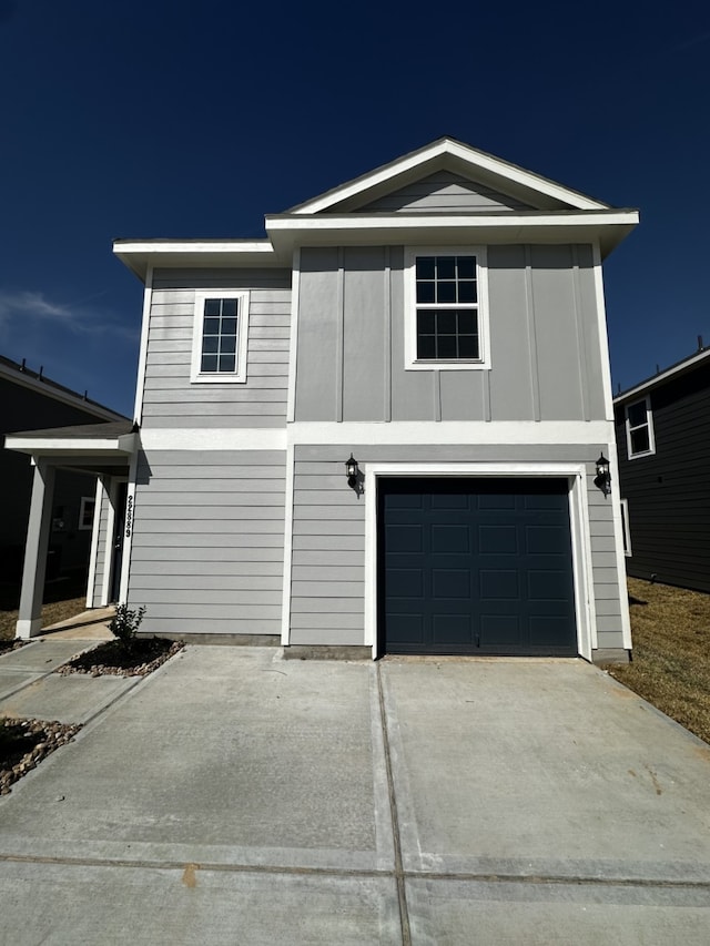 view of front of house with concrete driveway and an attached garage