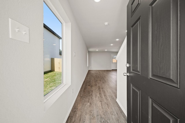 hall with baseboards, wood finished floors, and recessed lighting