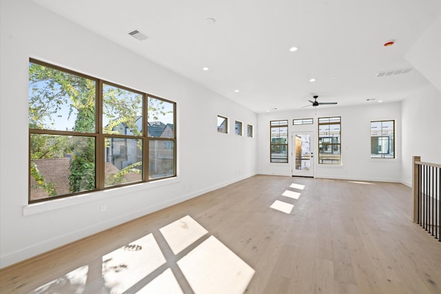 unfurnished living room with ceiling fan and light hardwood / wood-style flooring