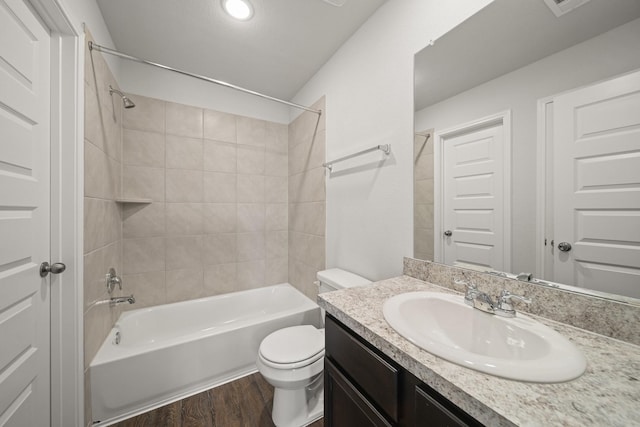 bathroom with vanity, bathtub / shower combination, wood finished floors, and toilet