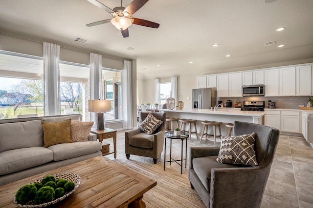 living room with sink and ceiling fan