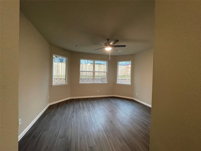 spare room featuring dark hardwood / wood-style flooring and ceiling fan