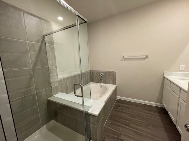 bathroom featuring vanity, hardwood / wood-style flooring, and independent shower and bath