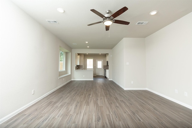 unfurnished living room featuring hardwood / wood-style flooring and ceiling fan