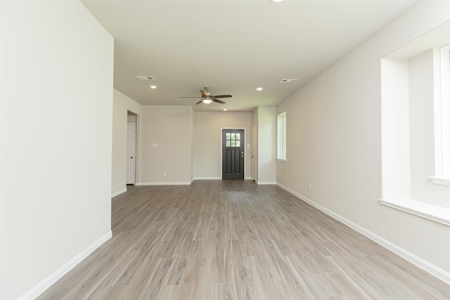 unfurnished living room with ceiling fan and light wood-type flooring