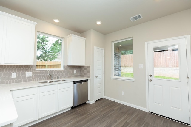 kitchen with white cabinetry, dishwasher, sink, and decorative backsplash