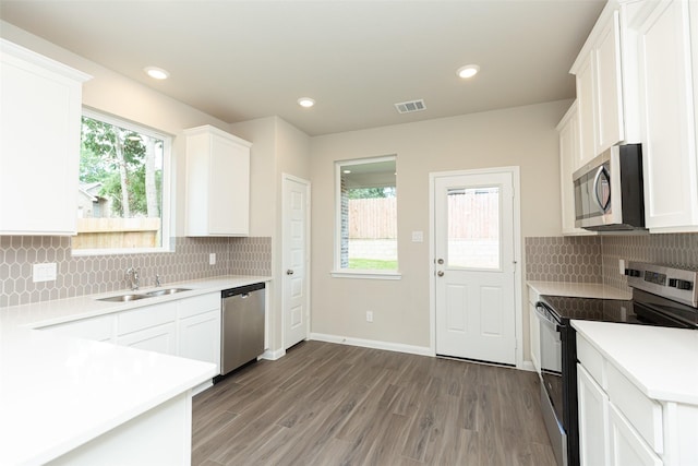 kitchen featuring appliances with stainless steel finishes, sink, and white cabinets