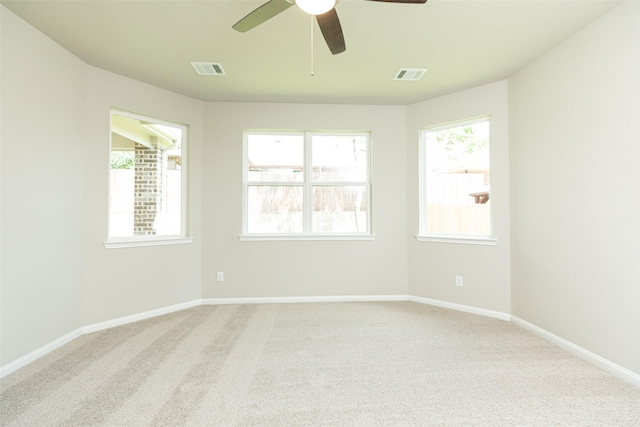 carpeted empty room featuring ceiling fan