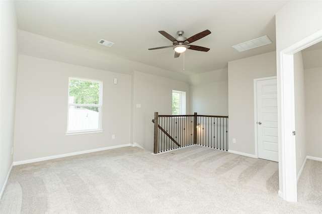 carpeted empty room with ceiling fan