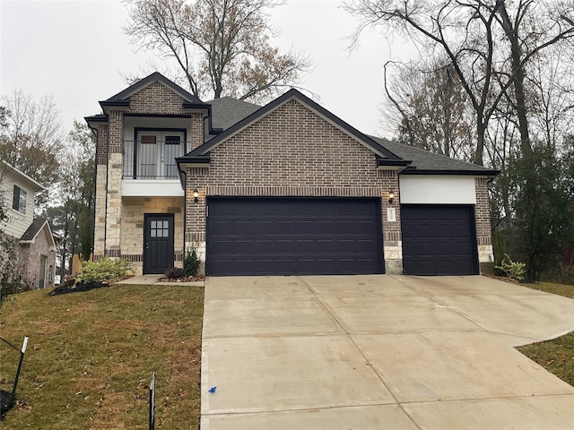 view of front of house with a garage, a front yard, and a balcony