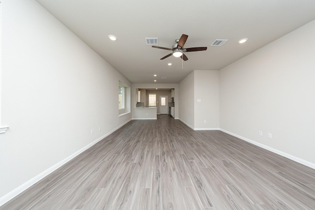 unfurnished living room with light wood-style floors, recessed lighting, visible vents, and baseboards