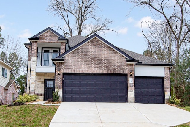 view of front of property with a garage, driveway, a balcony, stone siding, and brick siding