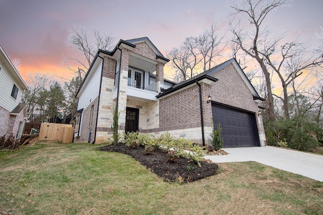 view of front facade with brick siding, driveway, a balcony, and an attached garage