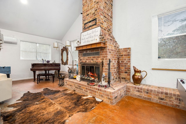 living room featuring a fireplace, concrete flooring, a wall mounted AC, and high vaulted ceiling