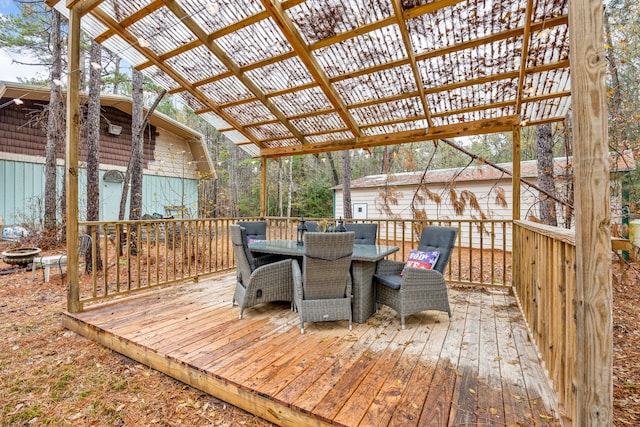 wooden terrace featuring a fire pit and a pergola