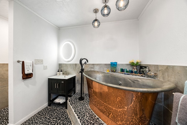 bathroom featuring ornamental molding, vanity, and a bathtub