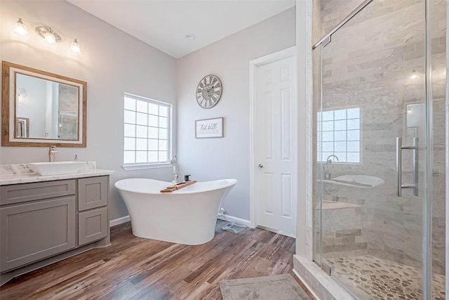 bathroom featuring vanity, hardwood / wood-style floors, and independent shower and bath