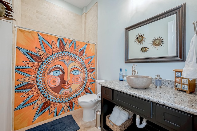 bathroom featuring tile patterned flooring, vanity, curtained shower, and toilet