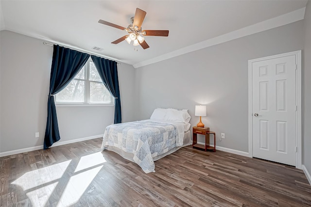 bedroom featuring crown molding, ceiling fan, and hardwood / wood-style floors