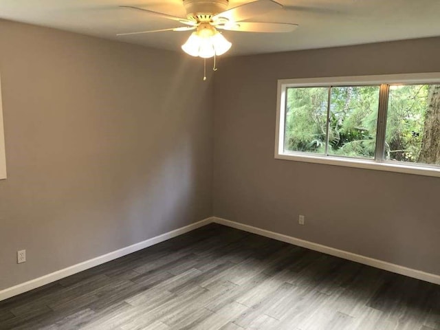 spare room featuring dark hardwood / wood-style floors and ceiling fan