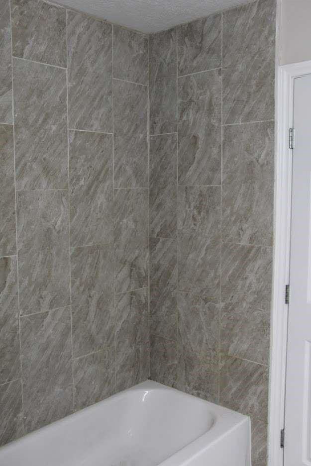 bathroom featuring a textured ceiling and a bathing tub