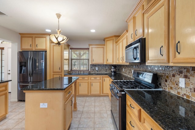 kitchen featuring a center island, hanging light fixtures, dark stone countertops, refrigerator with ice dispenser, and gas range oven