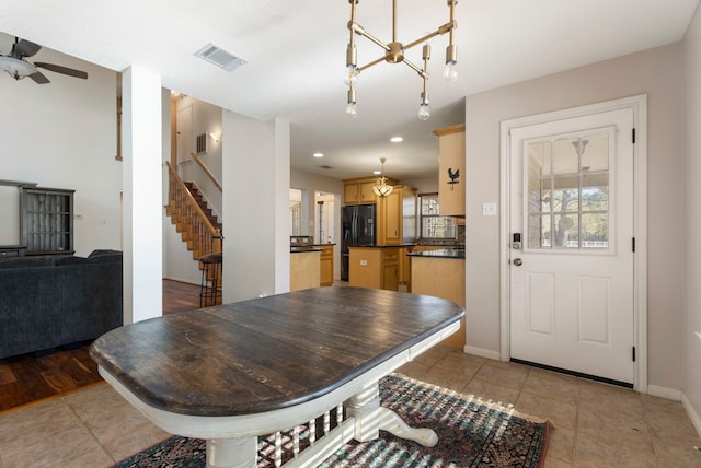 tiled dining area featuring ceiling fan