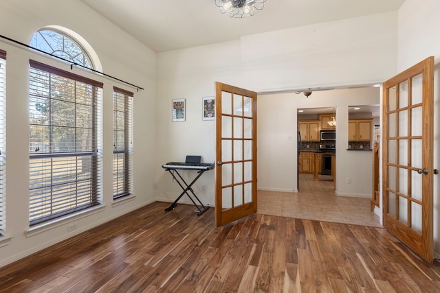 empty room with dark hardwood / wood-style floors and french doors