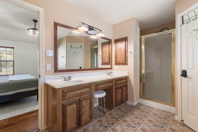 bathroom featuring vanity and an enclosed shower