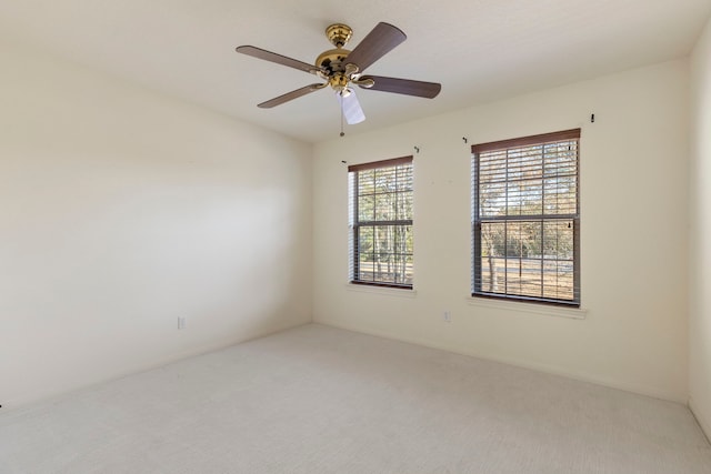 spare room with carpet and ceiling fan