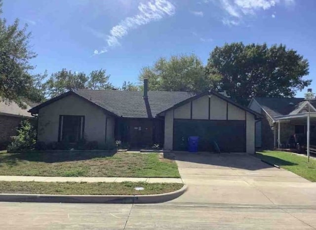 single story home with a garage and a front lawn