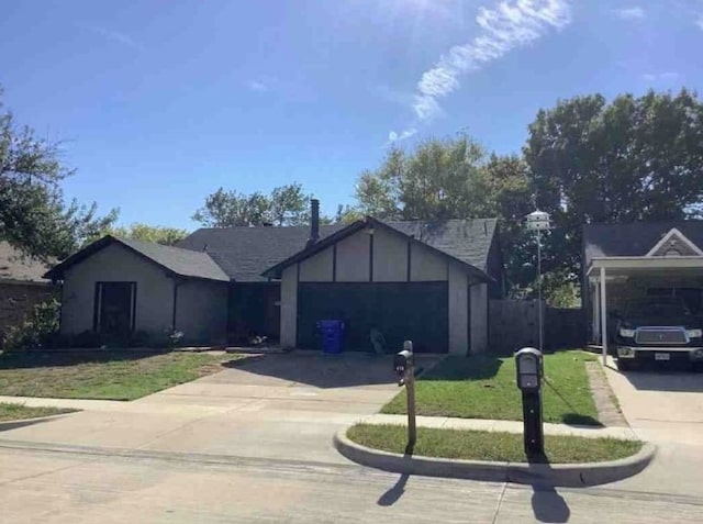 ranch-style house with a garage and a front yard