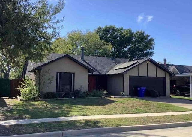 ranch-style house featuring a garage and a front yard