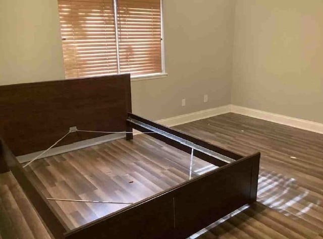 unfurnished bedroom with hardwood / wood-style flooring