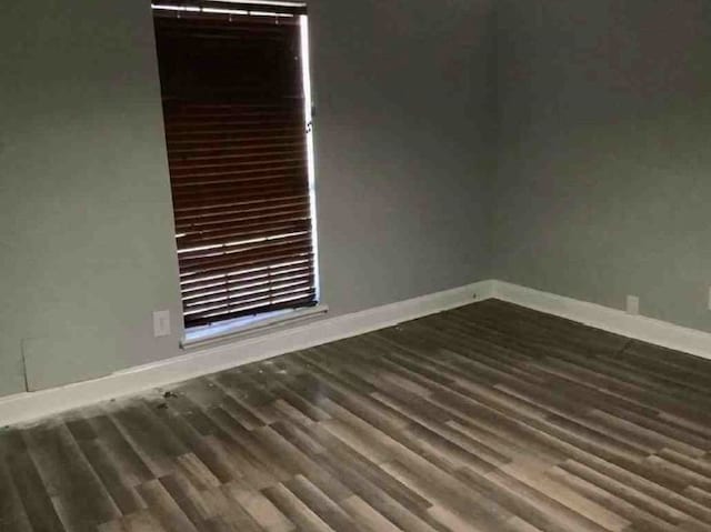 spare room with dark hardwood / wood-style floors