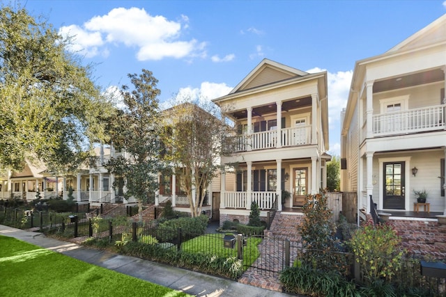 view of front of property featuring a balcony and a porch