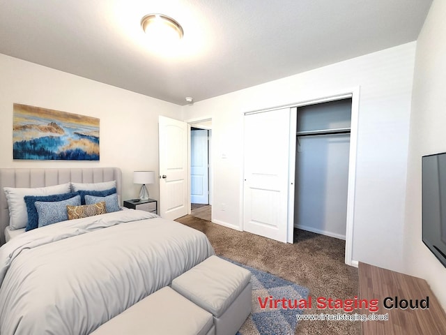 bedroom with a closet, dark carpet, and baseboards