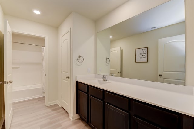 bathroom with vanity, hardwood / wood-style floors, and shower / bath combination with curtain