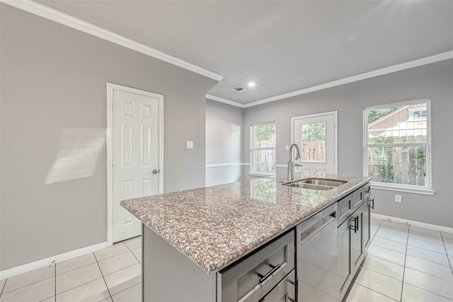 kitchen featuring sink, stainless steel dishwasher, light tile patterned floors, crown molding, and a center island with sink