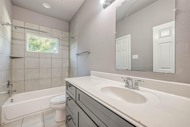 full bathroom with tile patterned flooring, vanity, tiled shower / bath combo, and toilet